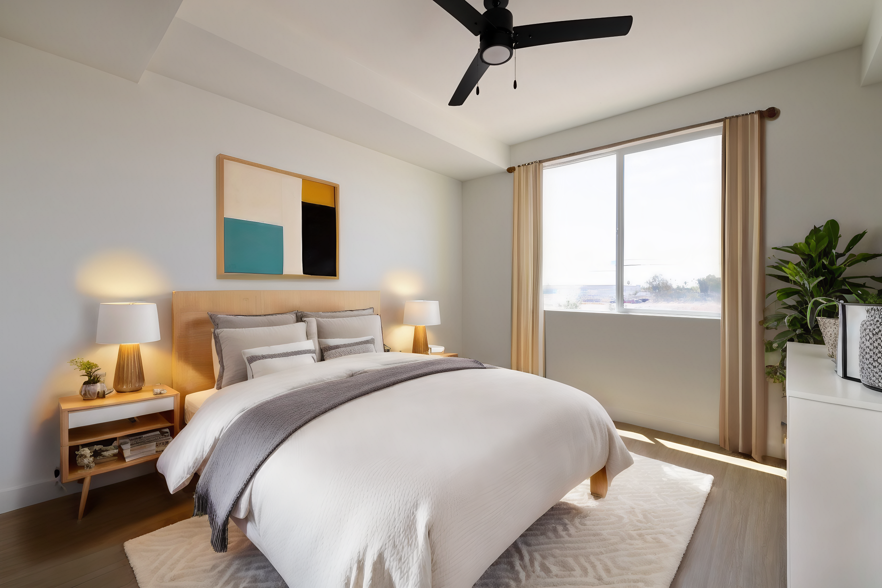 a bedroom with a ceiling fan and a bed at The Blue at Eastline